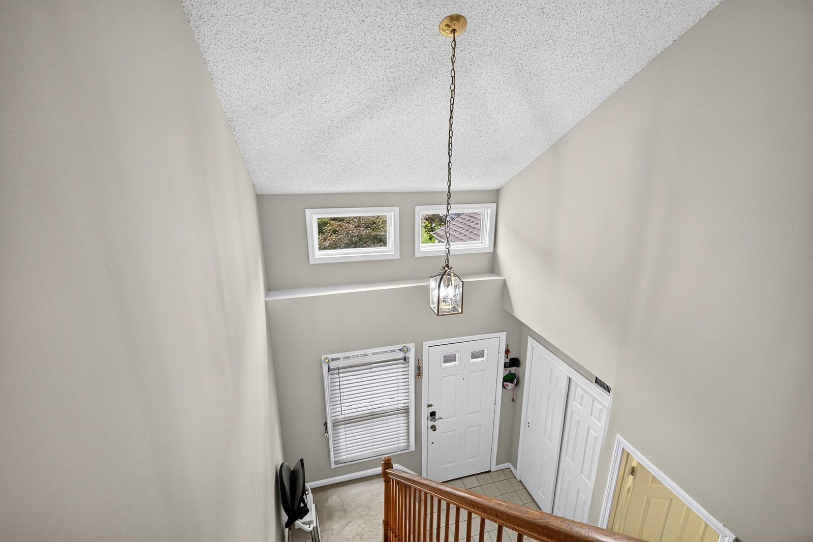 View down into the two-story foyer from the upstairs landing