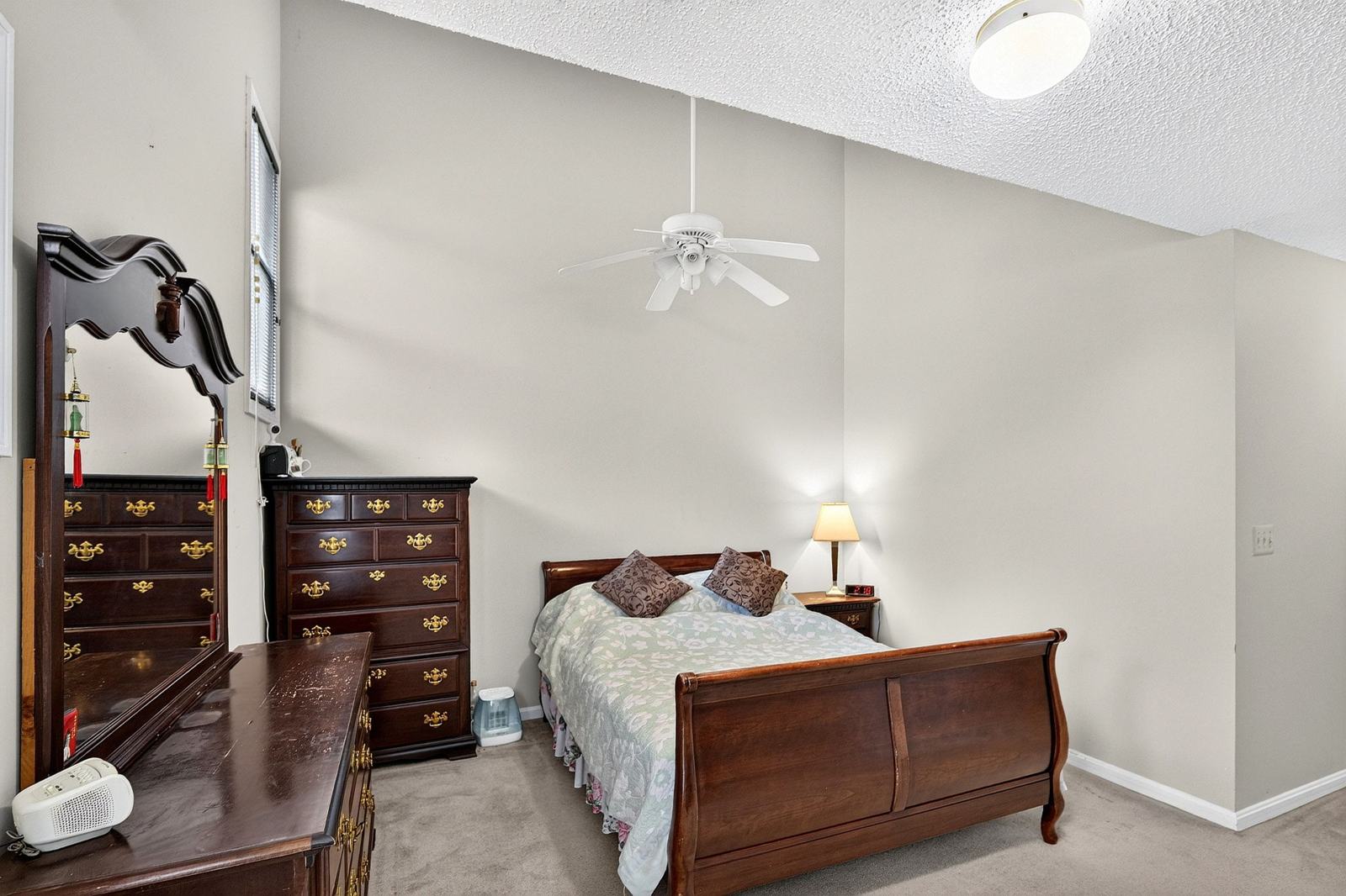 Second bedroom suite with a ceiling fan and carpet
